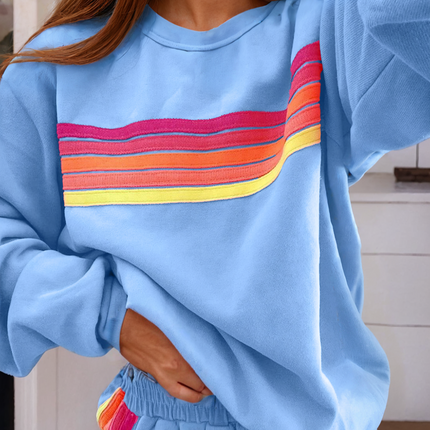 Blue sweatshirt with a colorful stripe design and matching shorts.